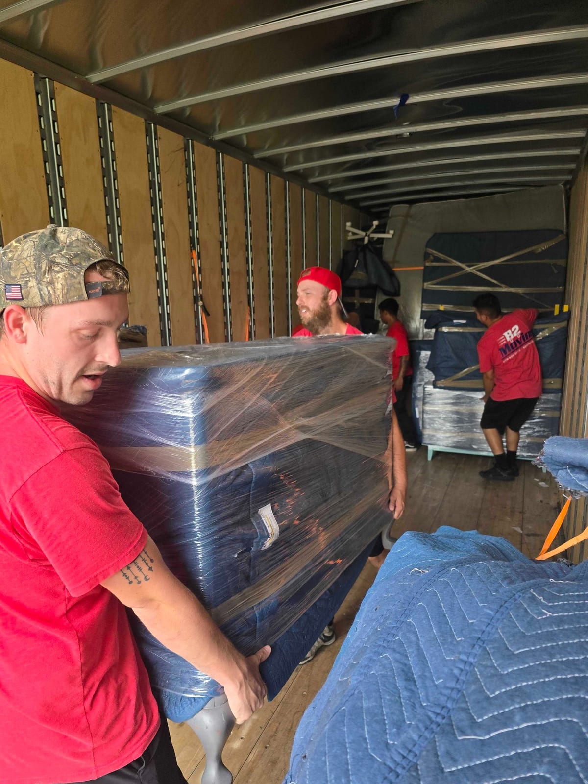 Dakota and Joe unloading protected furniture into a new Cave Springs home