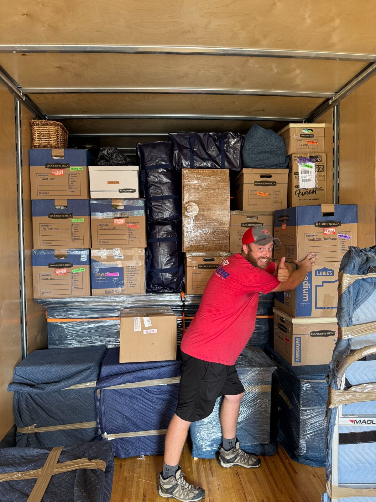 B2 mover Joe beside an organized moving-truck load from a Centerton move
