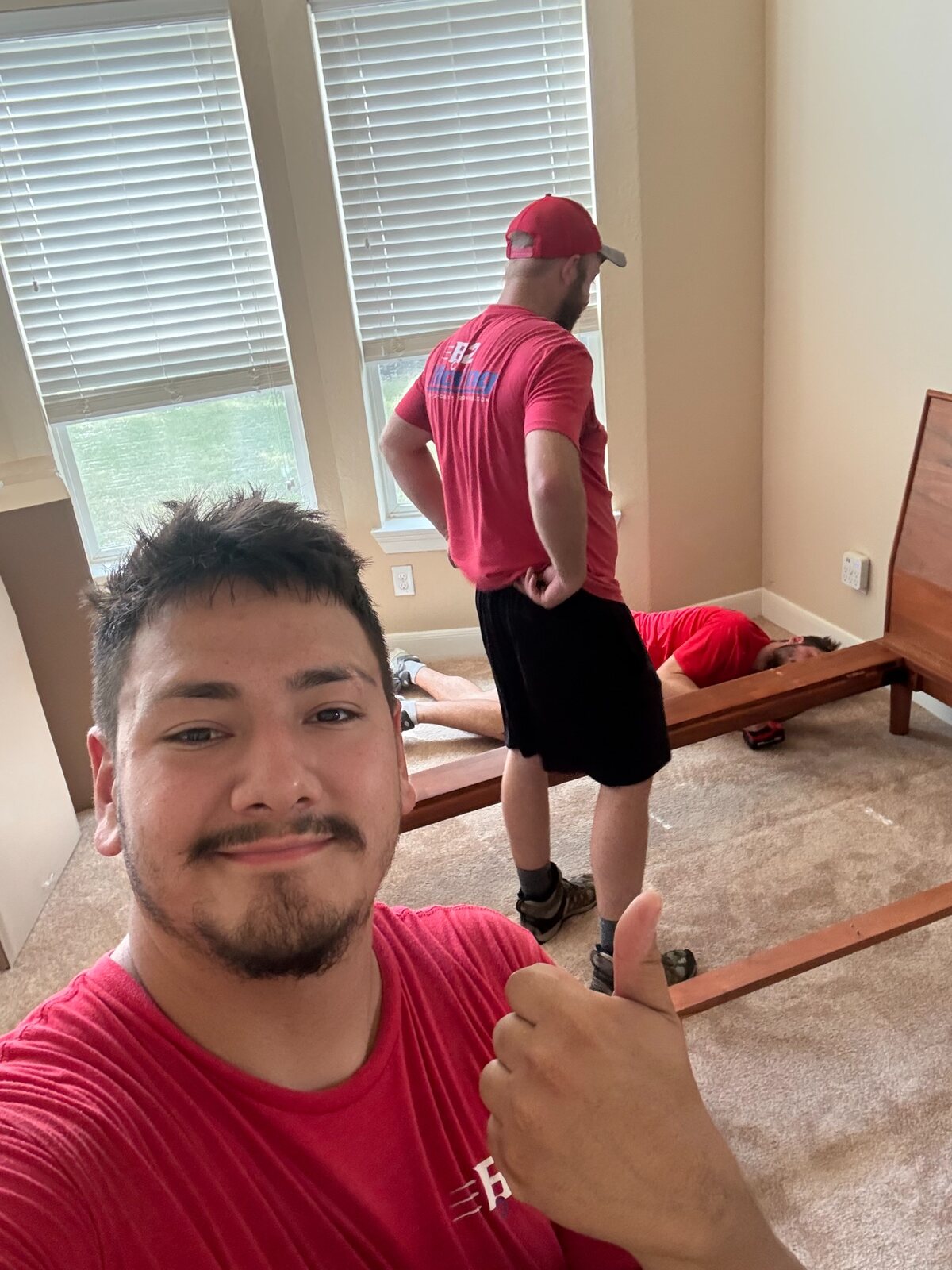 Socimo and B2 teammates assembling a bed during a Pea Ridge move
