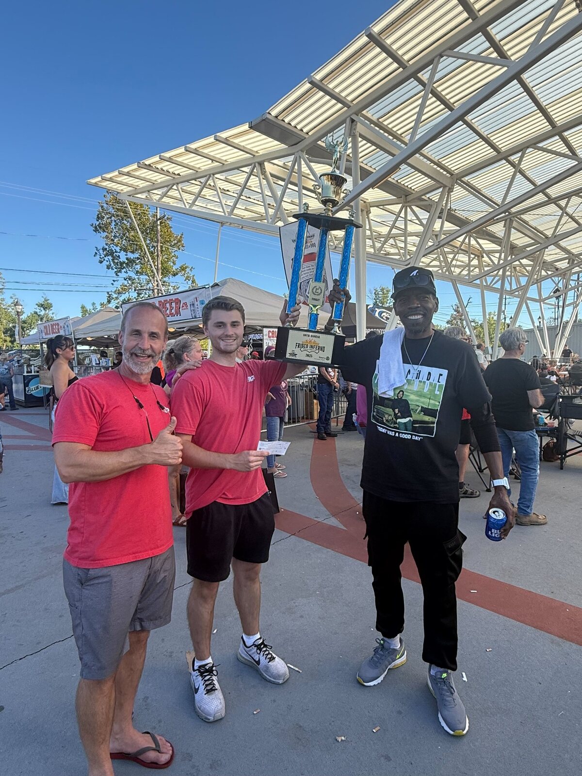 Dolph, Myers, and Adam holding B2 Moving's first-place trophy at the 2025 Frisco Inferno in Rogers