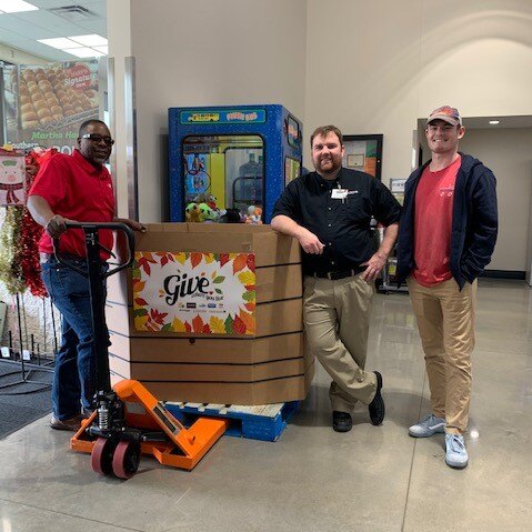Jesse and Sam with a Harps teammate and food-drive donations