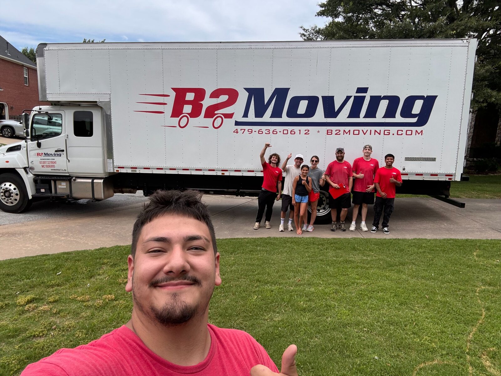 Socimo, Joe, Dakota, Riley, and Frank with customers after a Rogers move